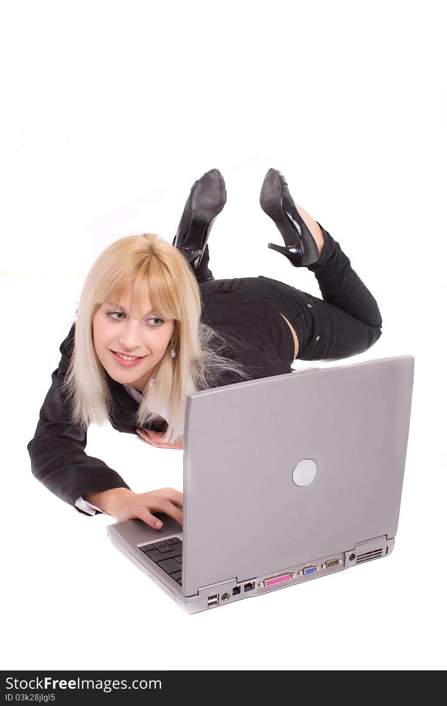 Young woman lying and looking at laptop. Young woman lying and looking at laptop