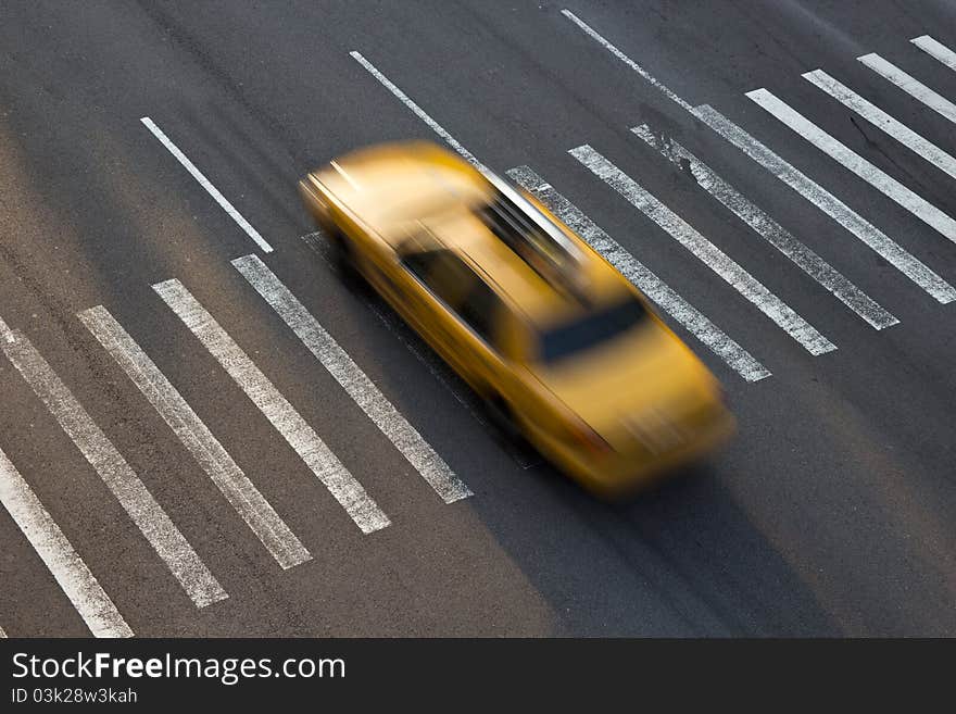 Yellow taxi of New York traversing a zebra crossing. Yellow taxi of New York traversing a zebra crossing