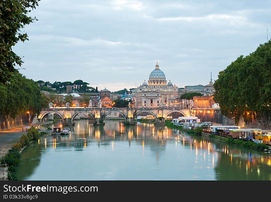 Evening view at the Angelo bridge and St. Peter's Basilica in Rome, Italy