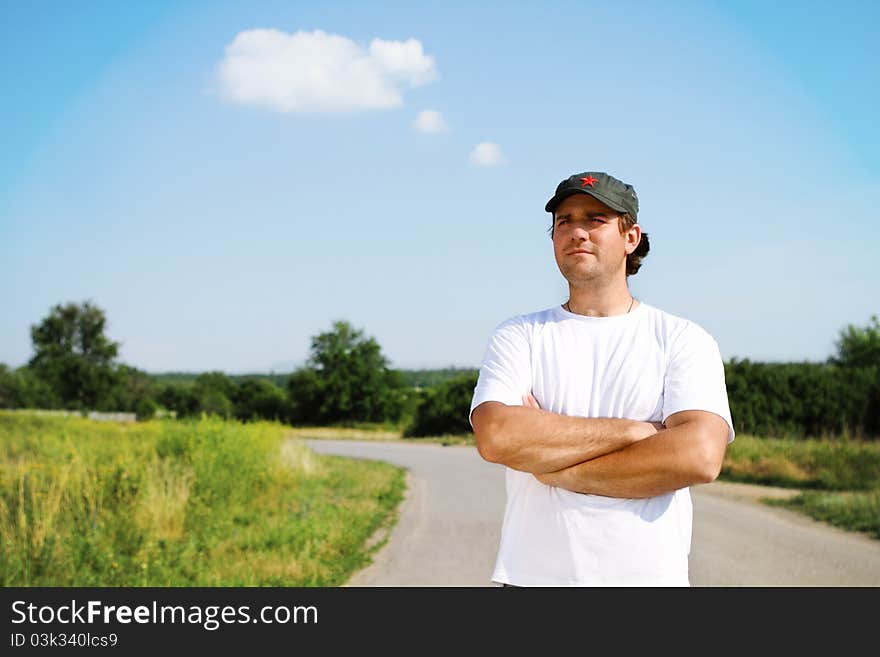 Thinking man outdoors looking forward on the road