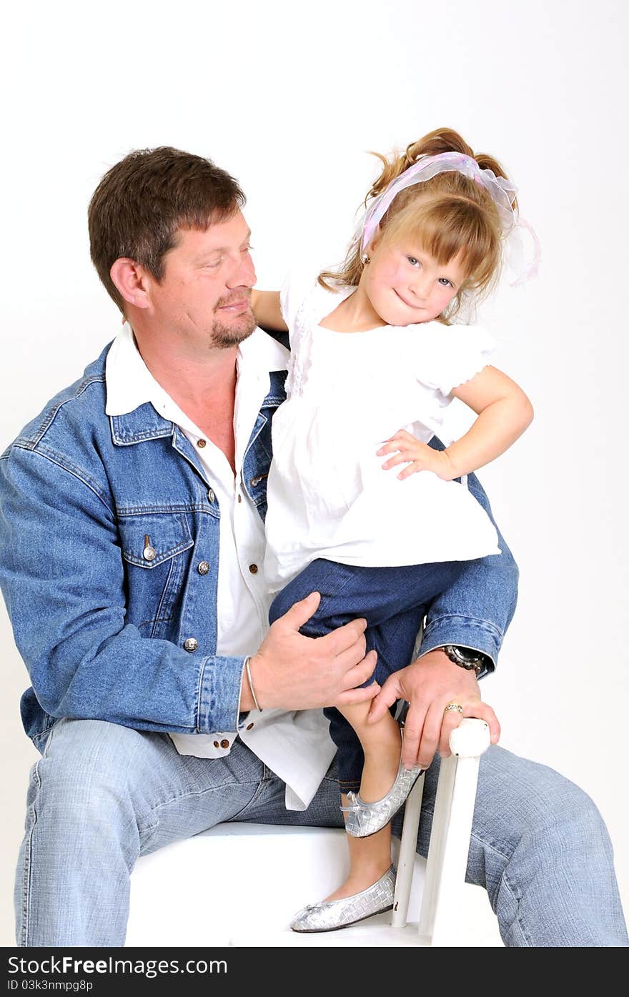 Young father and toddler girl dressed in white