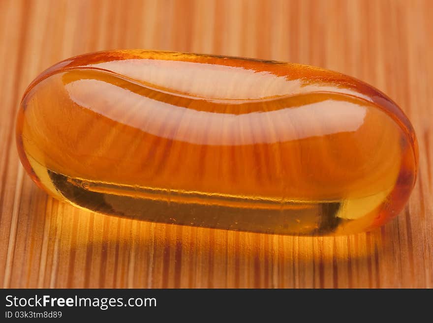 Medical pill against diseases on a wooden table.