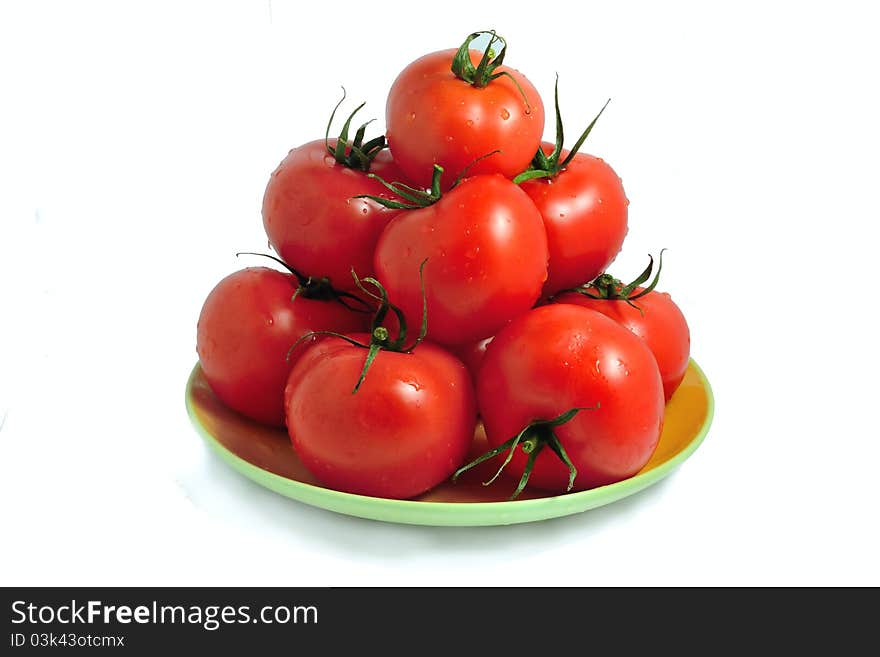 The fresh tomatoes isolated on a plate. The fresh tomatoes isolated on a plate