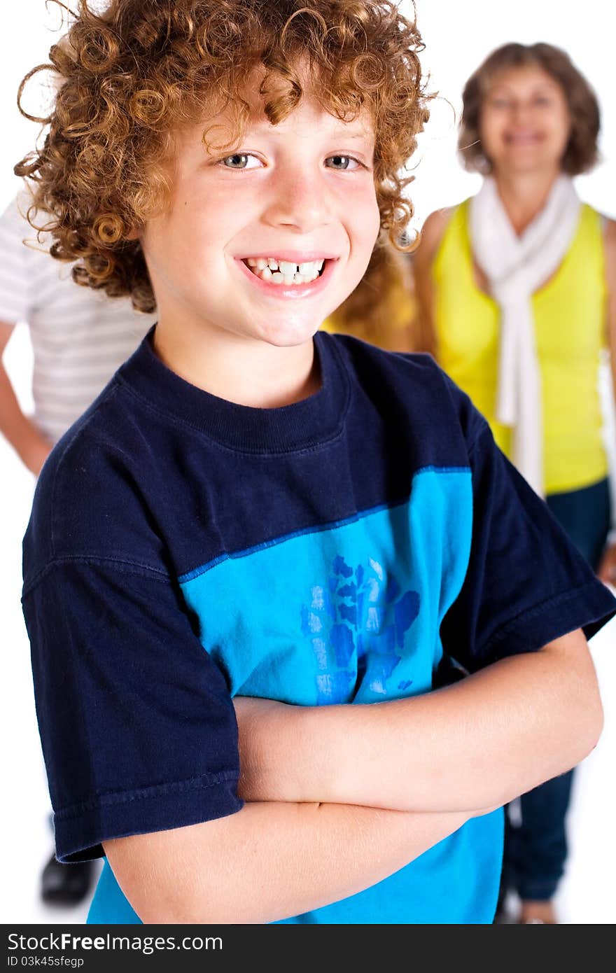 Young cute boy in focus with family in the background, isolated over white.