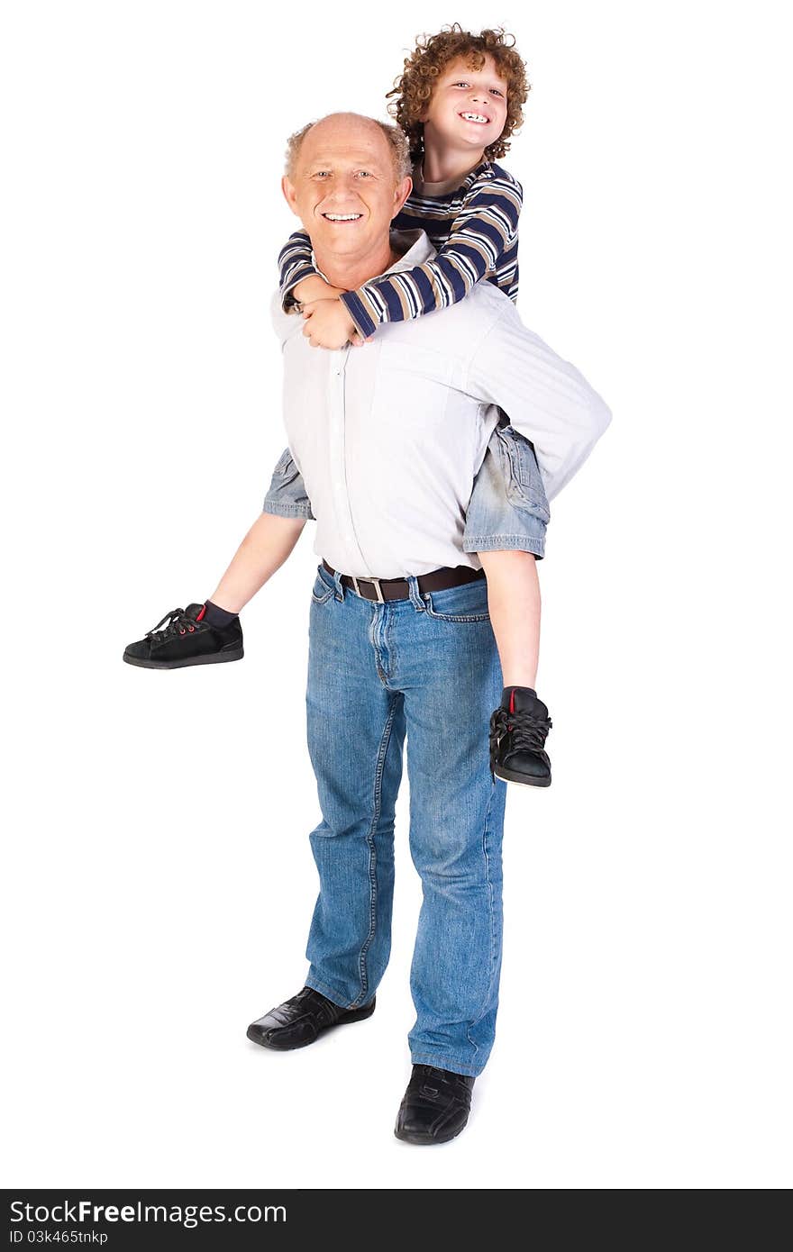 Grandfather giving grandson piggy-back against white background.