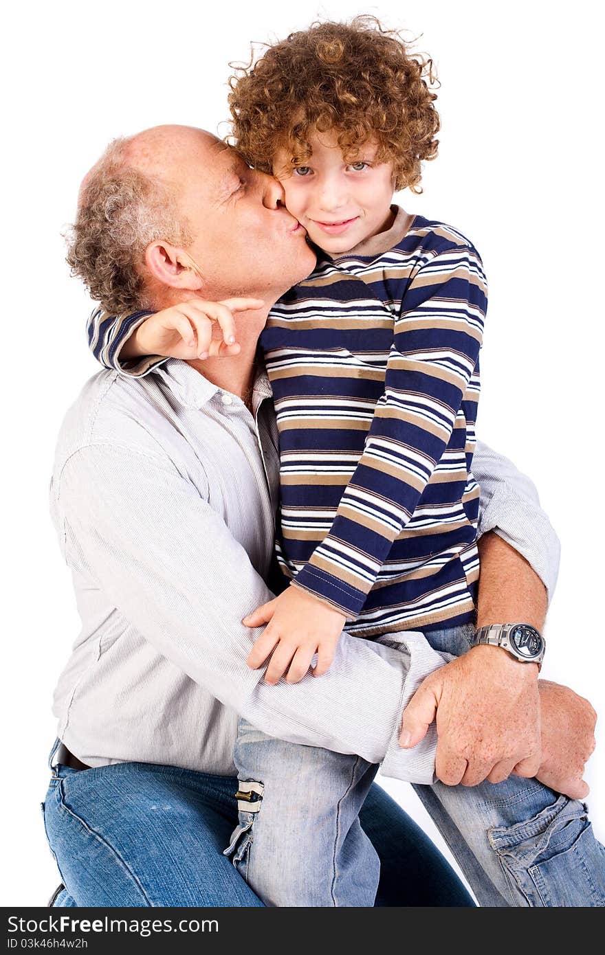 Grandson kissing his grandfather isolated on white background.