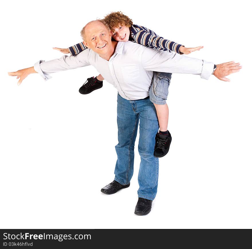 Grandfather giving grandson piggy-back against white background.