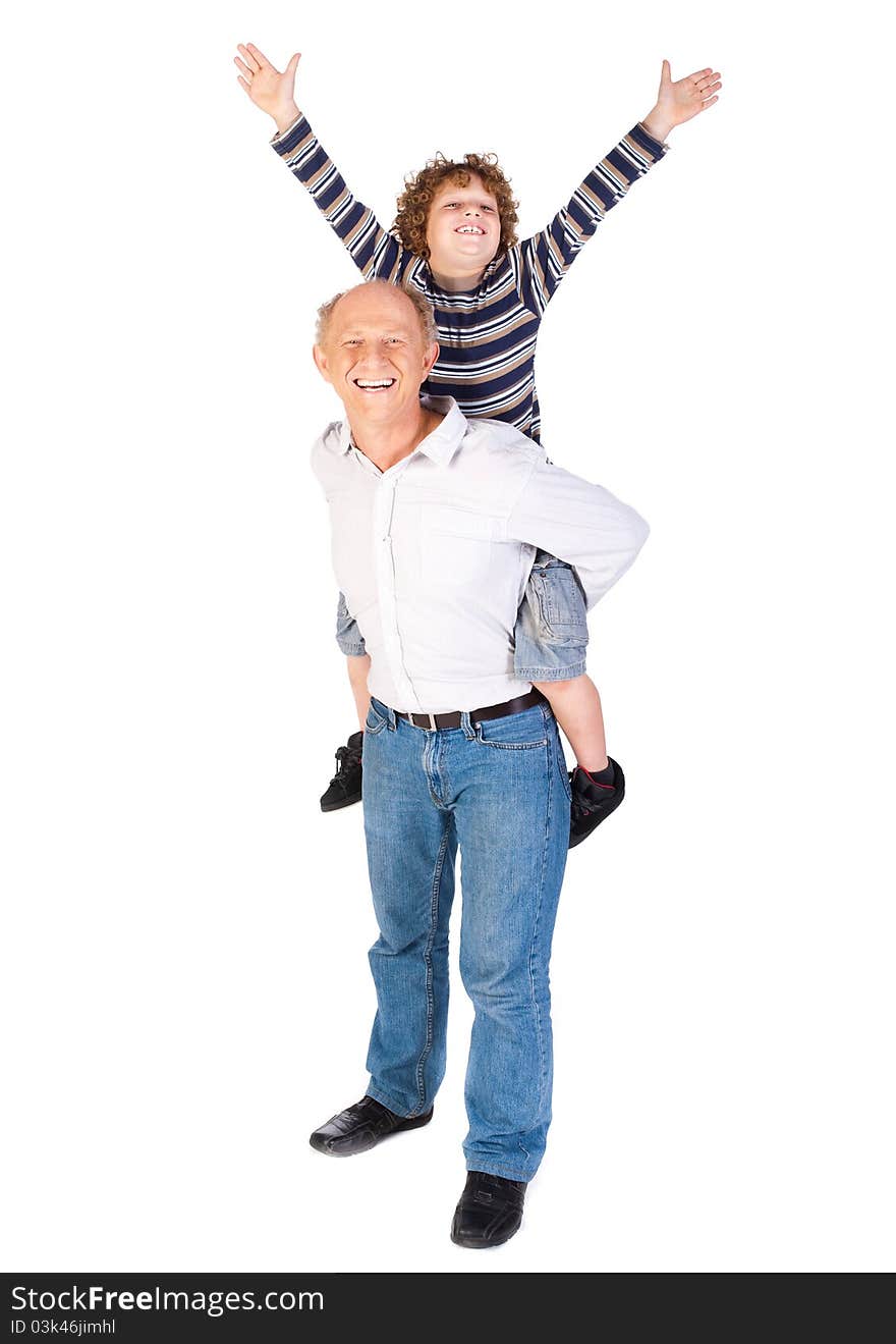 Grandfather giving grandson piggy-back against white background.