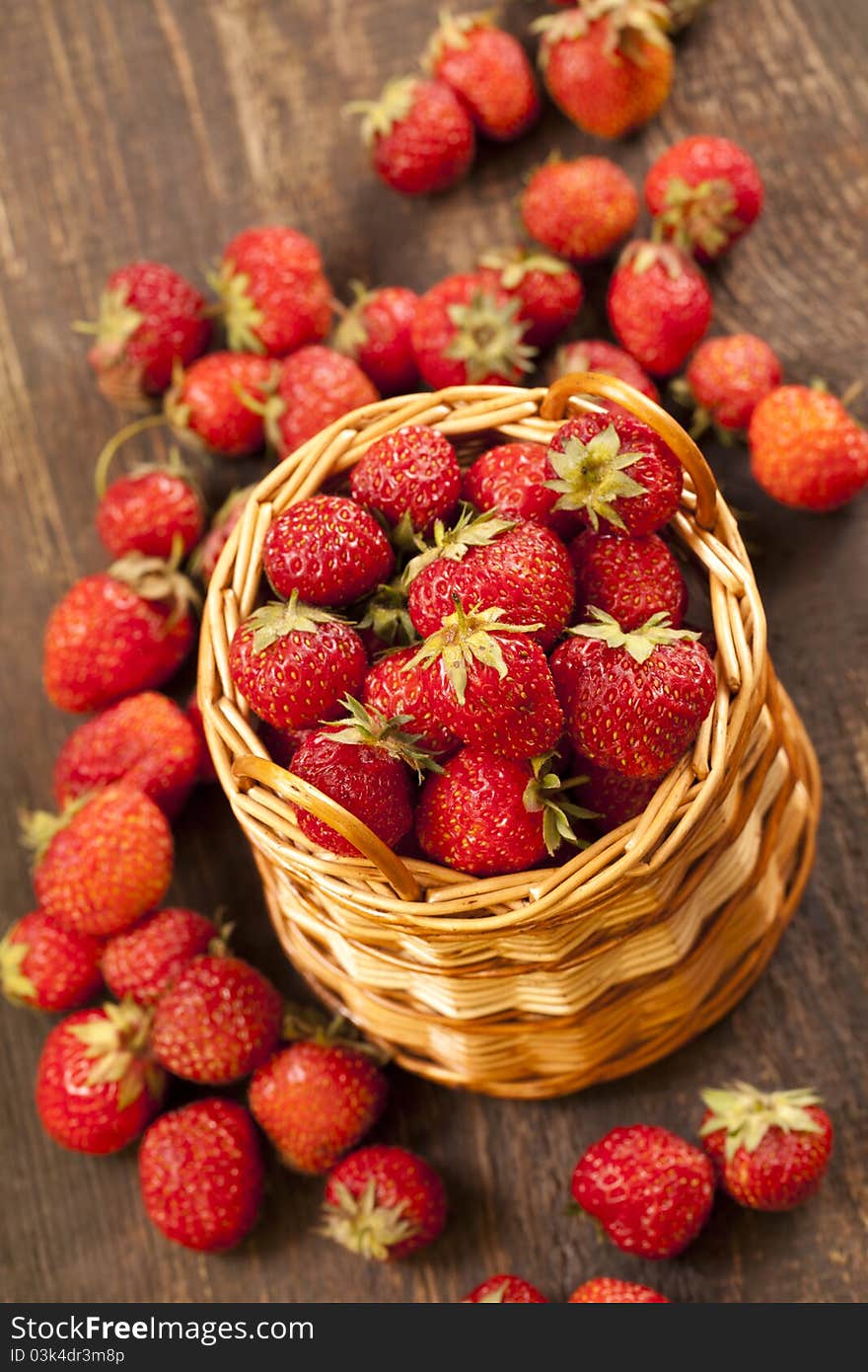 Strawberries in a basket and cheese, are a number of chamomile flowers, environmentally friendly product