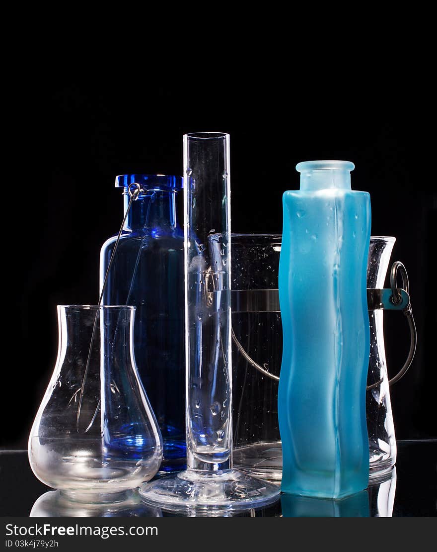 Group of beautiful handmade vases on a black background with illumination from behind