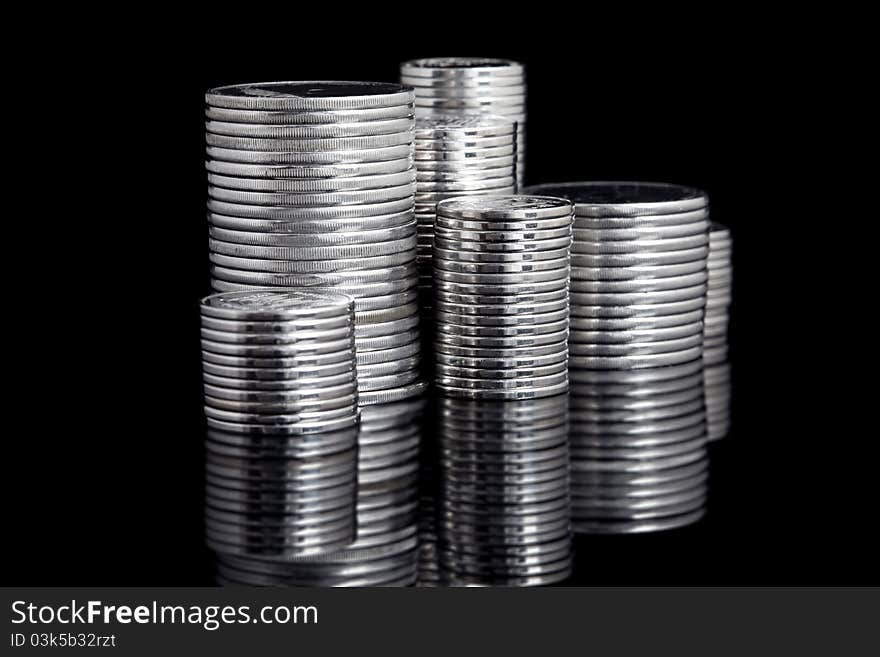 Silver coin stack on black background