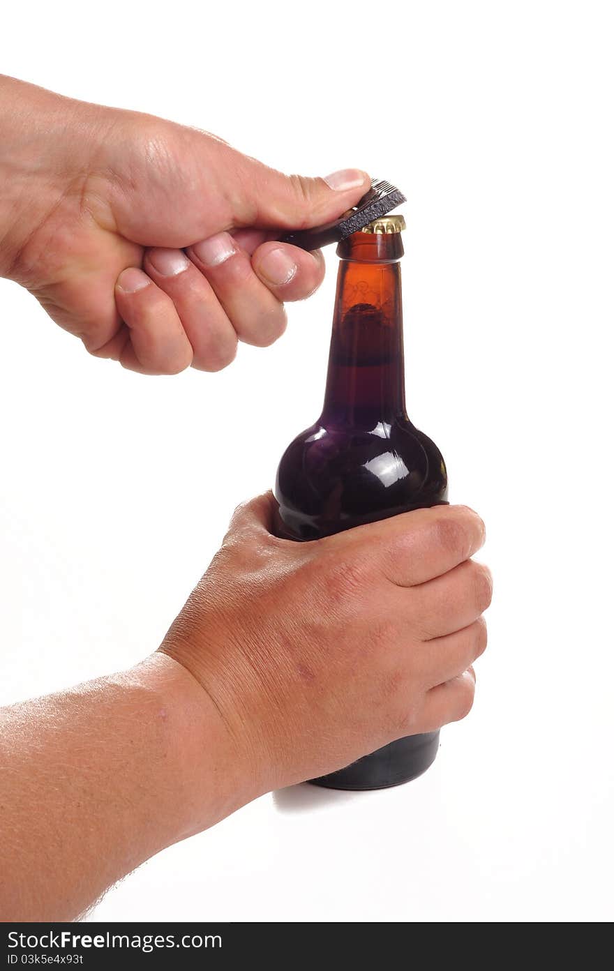 Photograph of human hands opening a bottle of beer