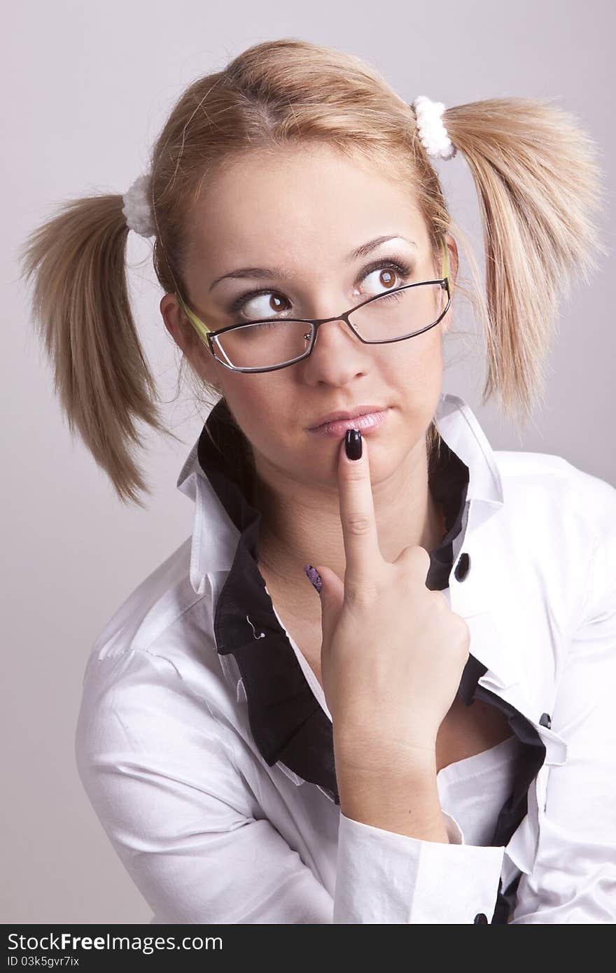 Portrait of a beautiful girl funny with blond hair wearing glasses and with tails on the head. Portrait of a beautiful girl funny with blond hair wearing glasses and with tails on the head