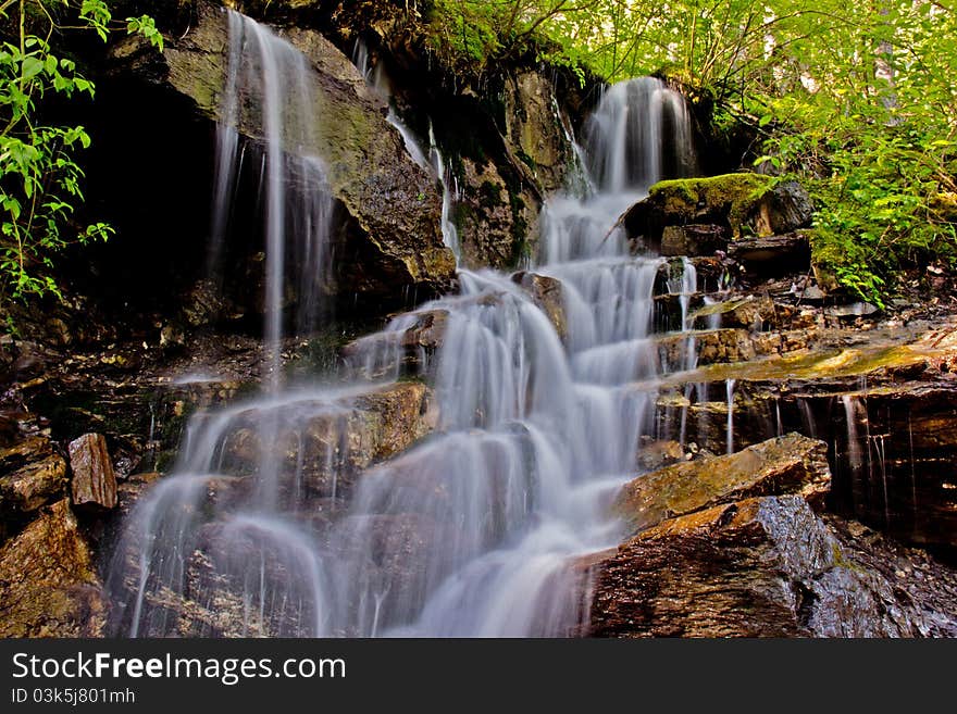 This image of the stream fed by snow melt and flowing down a series of rocky steps was taken at a very slow shutter speed in NW Montana. This image of the stream fed by snow melt and flowing down a series of rocky steps was taken at a very slow shutter speed in NW Montana.