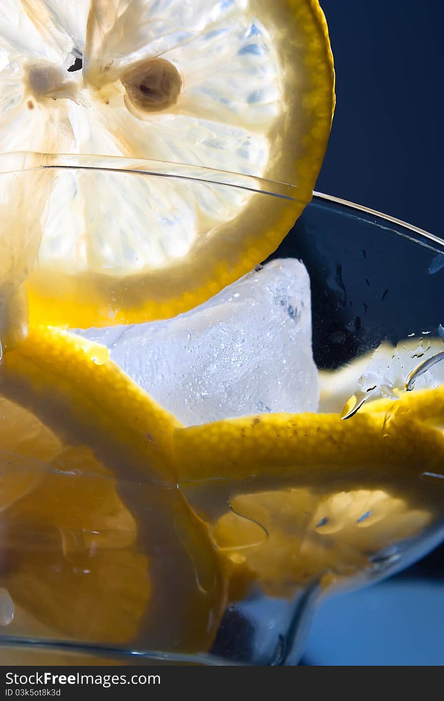 Close up of lemon wedge in glass of ice water. Close up of lemon wedge in glass of ice water