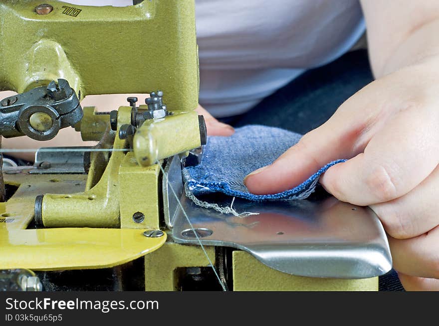 The picture shows a seamstress at work. The picture shows a seamstress at work