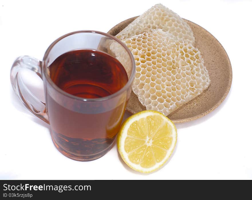 Black tea, half lemon and honeycomb isolated on white. Black tea, half lemon and honeycomb isolated on white