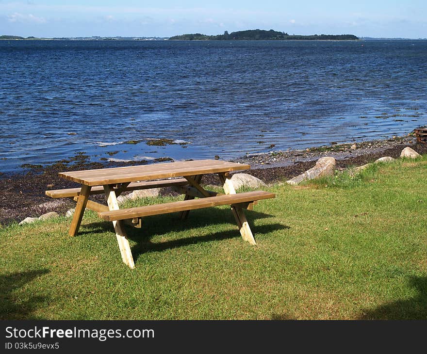 Outdoors Picnic table by the beach with sea ocean background