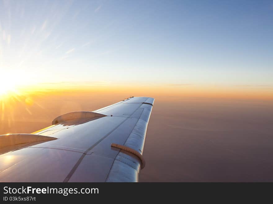 Sunset Above Wing Of An Airplane With Romantic Sky