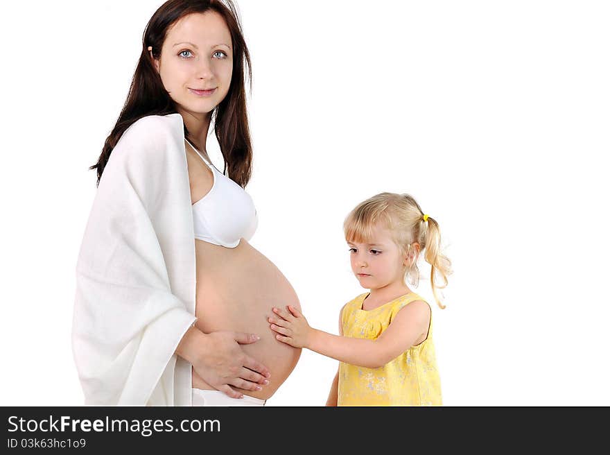 Little girl touches the belly of his pregnant mom. Little girl touches the belly of his pregnant mom