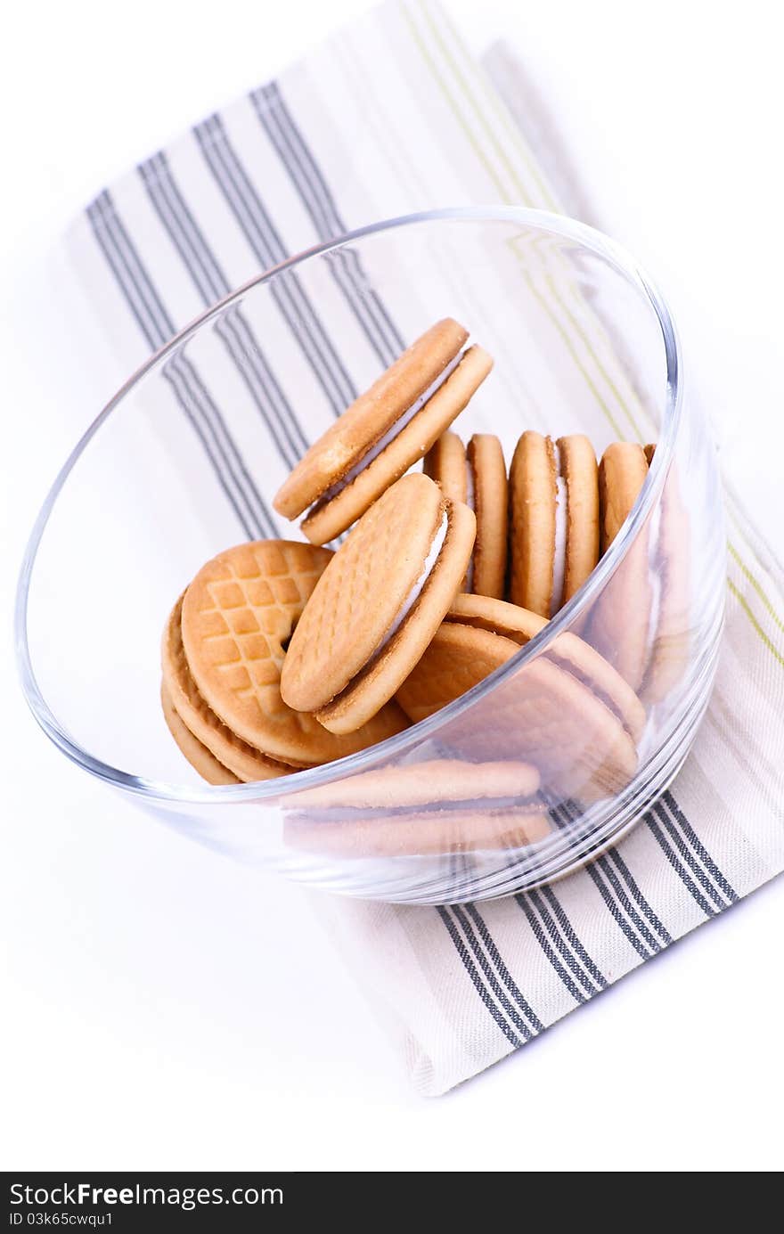 Cookies in a glass dish on white background