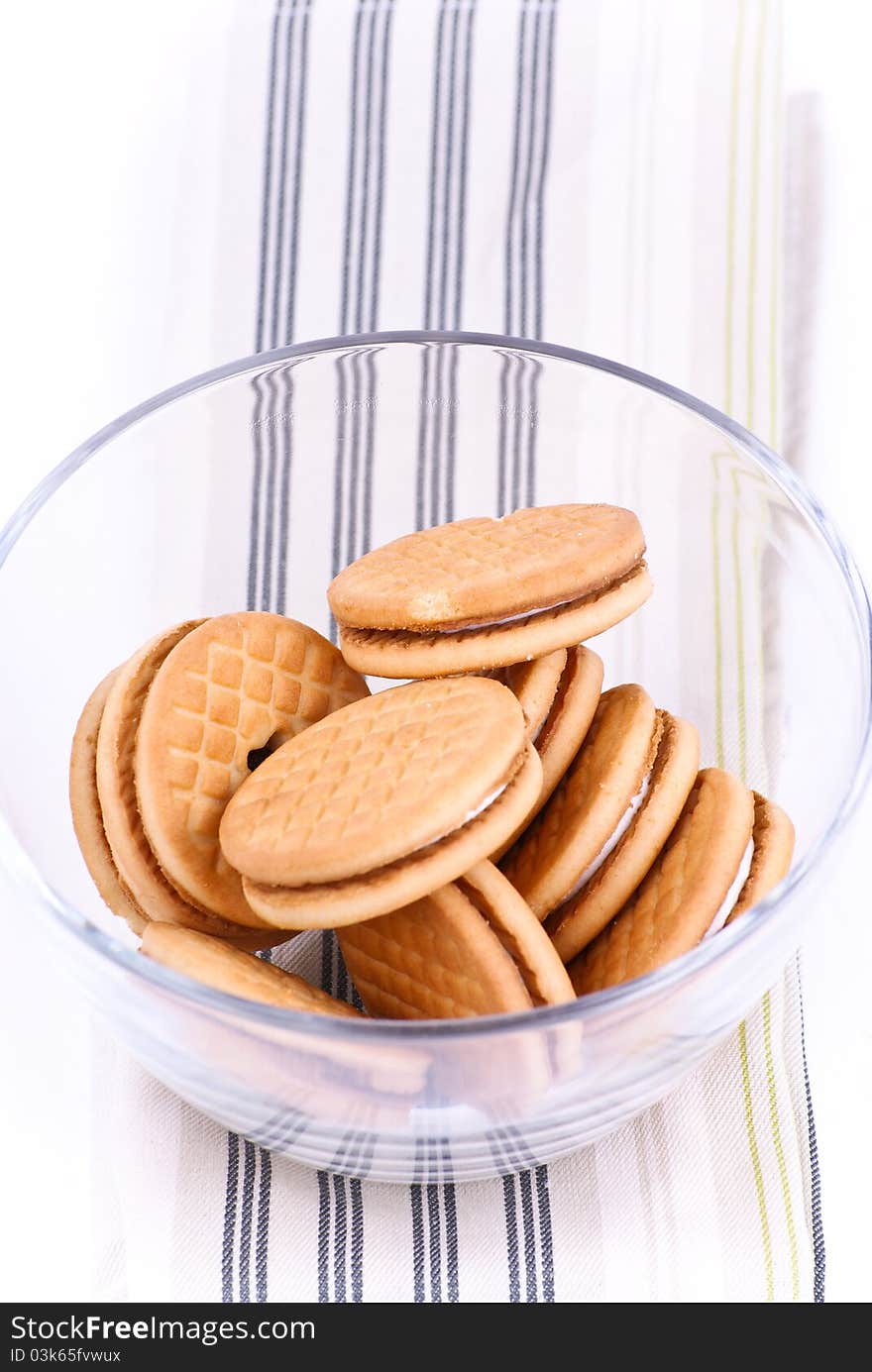 Cookies in a glass dish on white background