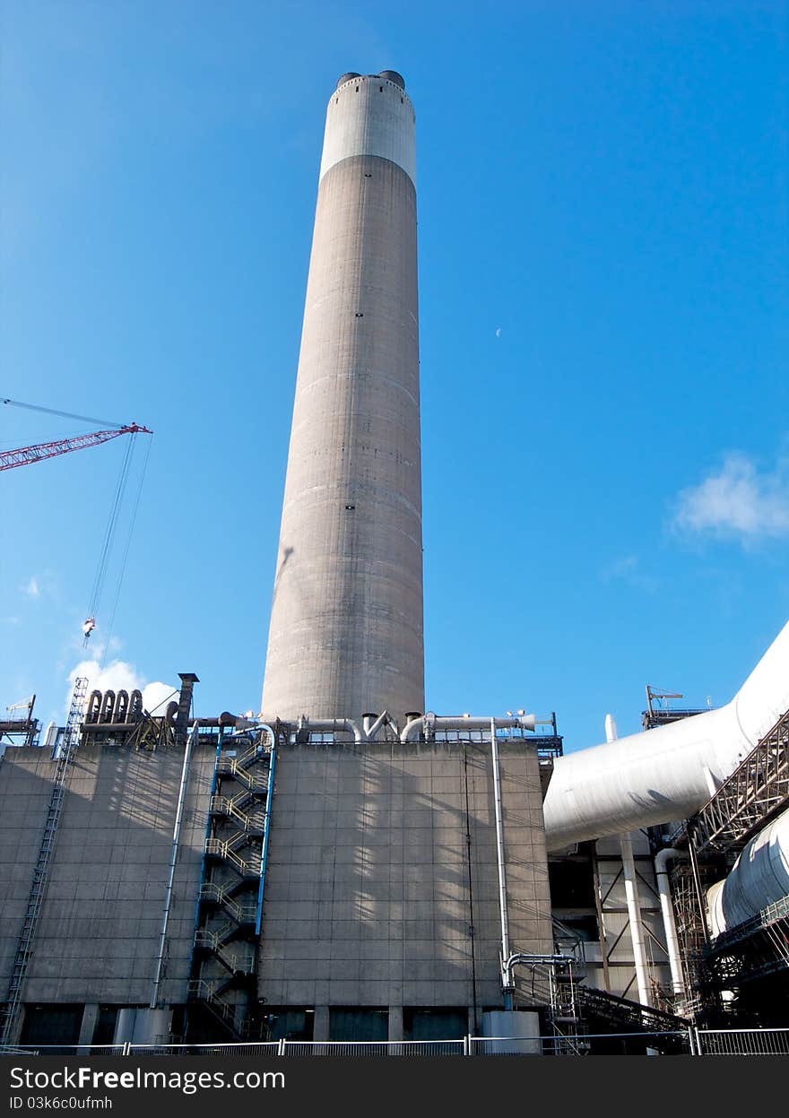 Coal fired power station chimney in the early morning sunlight