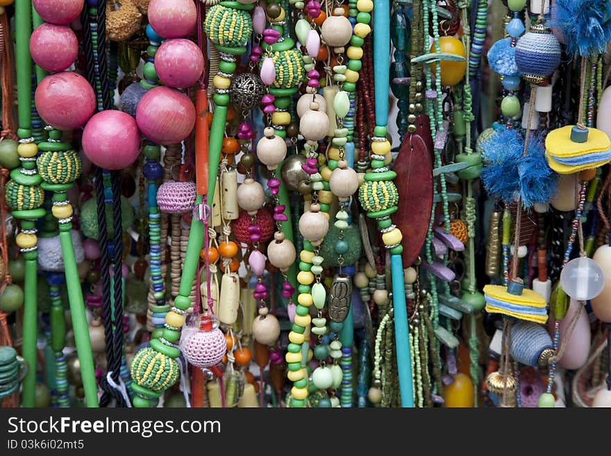 Multi-colored necklaces and other complements on sale on market stall. Multi-colored necklaces and other complements on sale on market stall