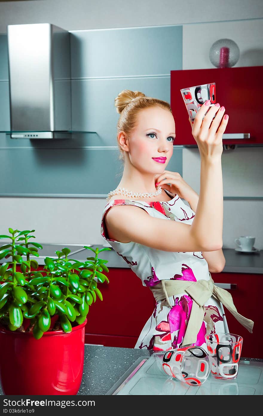 Housewife With Clean Glass In Interior Of Kitchen