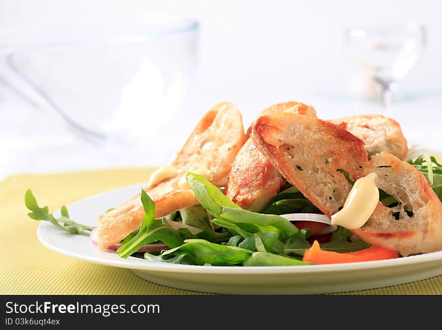 Salad greens with pieces of chicken and crispy bread. Salad greens with pieces of chicken and crispy bread