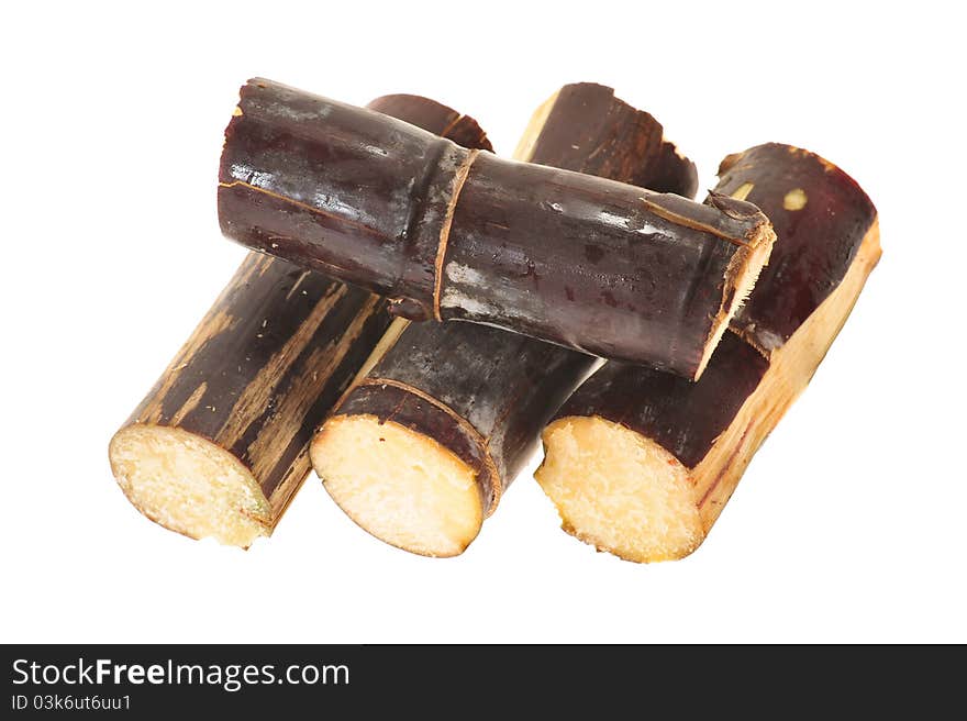 Short Stumps Of Maroon Colored Sugarcane Arranged On A White Background