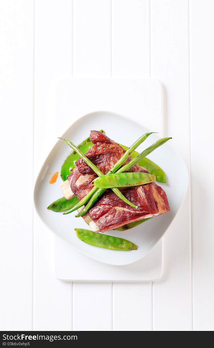 Smoked pork ribs with stir-fried string beans and snow peas