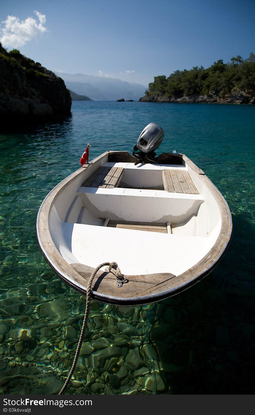 Boat on a remote beach with clear water. Boat on a remote beach with clear water