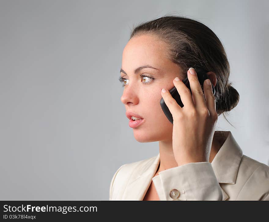 Young businesswoman talking on the mobile phone. Young businesswoman talking on the mobile phone