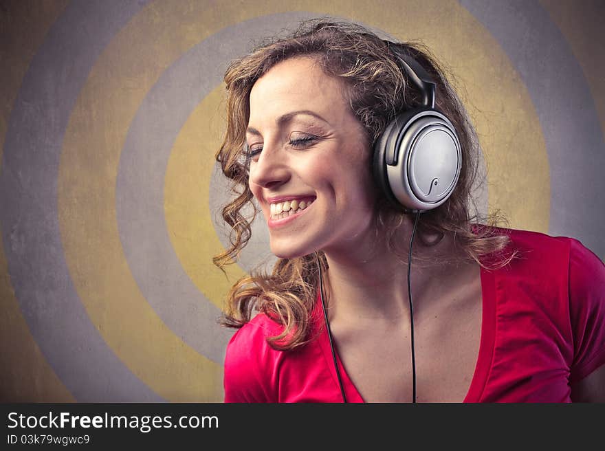 Smiling beautiful woman listening to music. Smiling beautiful woman listening to music