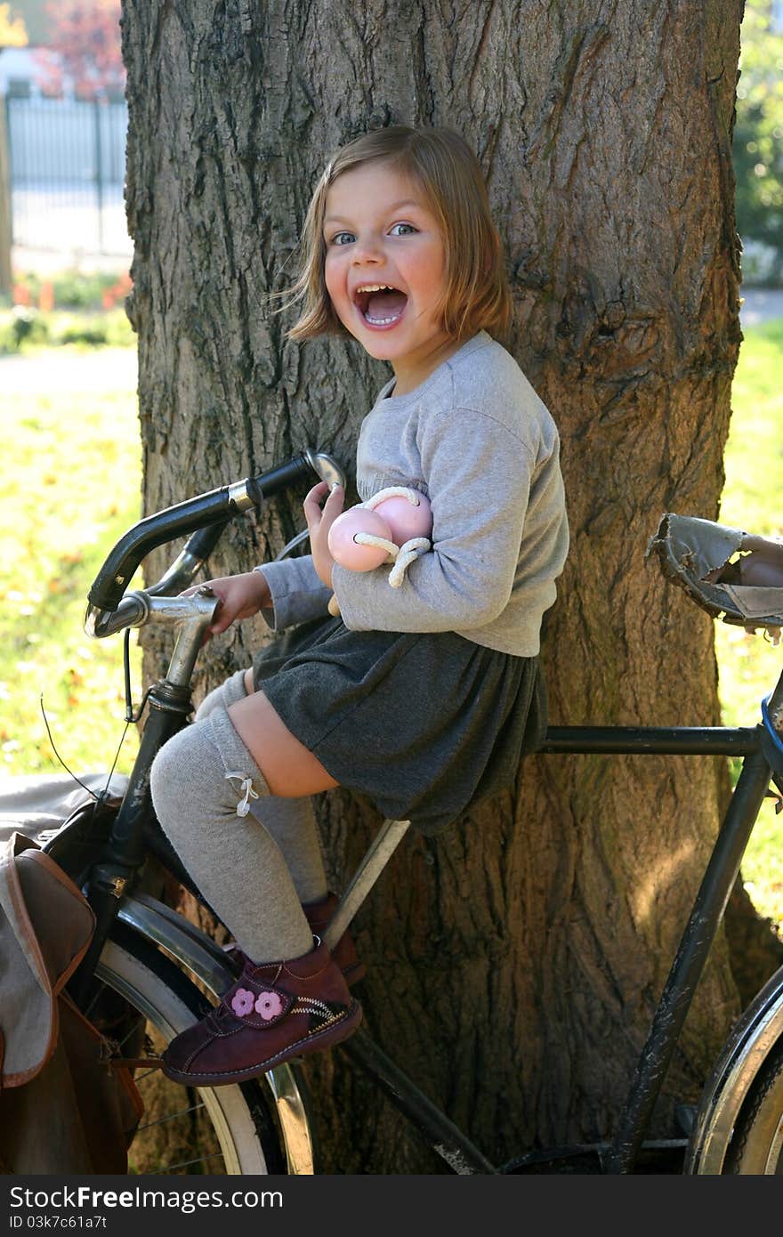 Young school sitting on old cycle. Young school sitting on old cycle