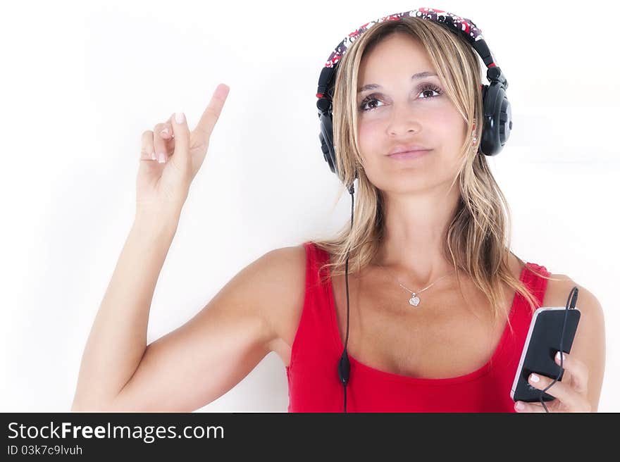 Trendy woman listening to music on her mp3 player wearing headphones. Trendy woman listening to music on her mp3 player wearing headphones