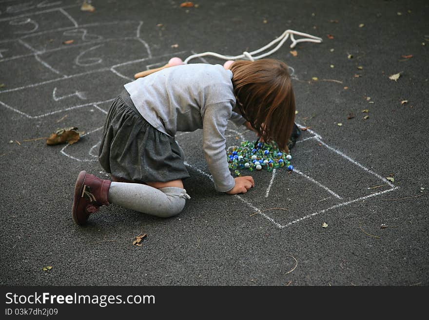 Young school girl playing on the street. Young school girl playing on the street