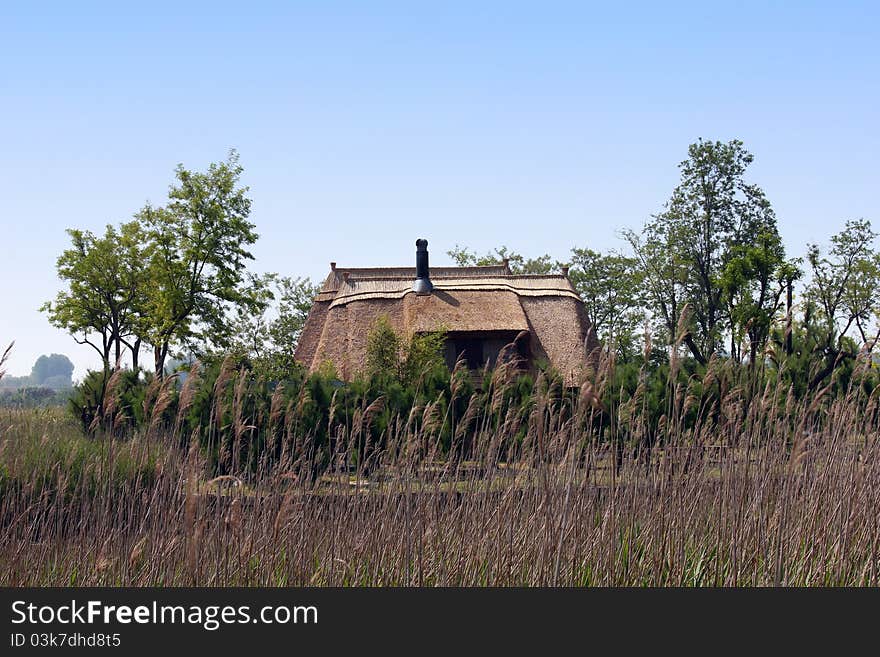 An old fishing hut with a roof of reed in the mediterranean area