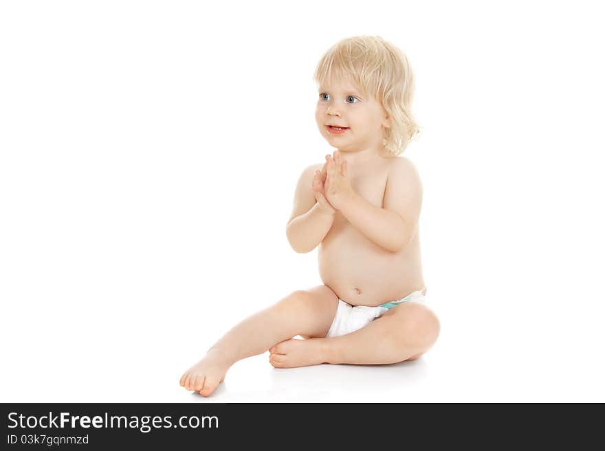 Sweet baby girl claps her hands isolated on white