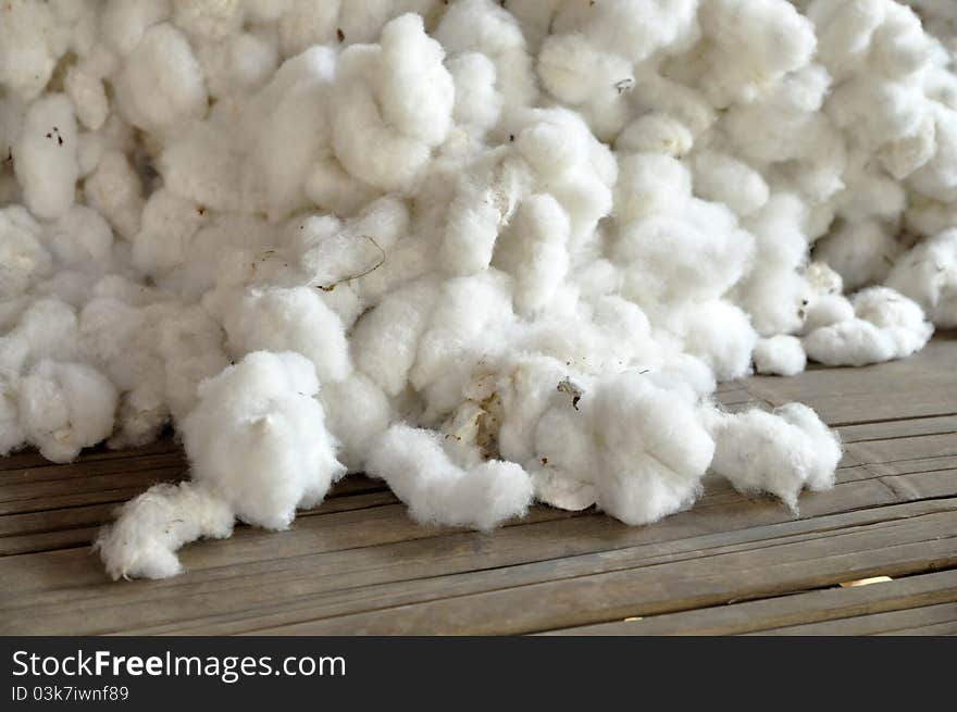 The pile of raw cotton together. In the agricultural sector. The pile of raw cotton together. In the agricultural sector.