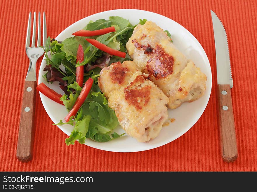 Rolls of turkey with salad on a plate