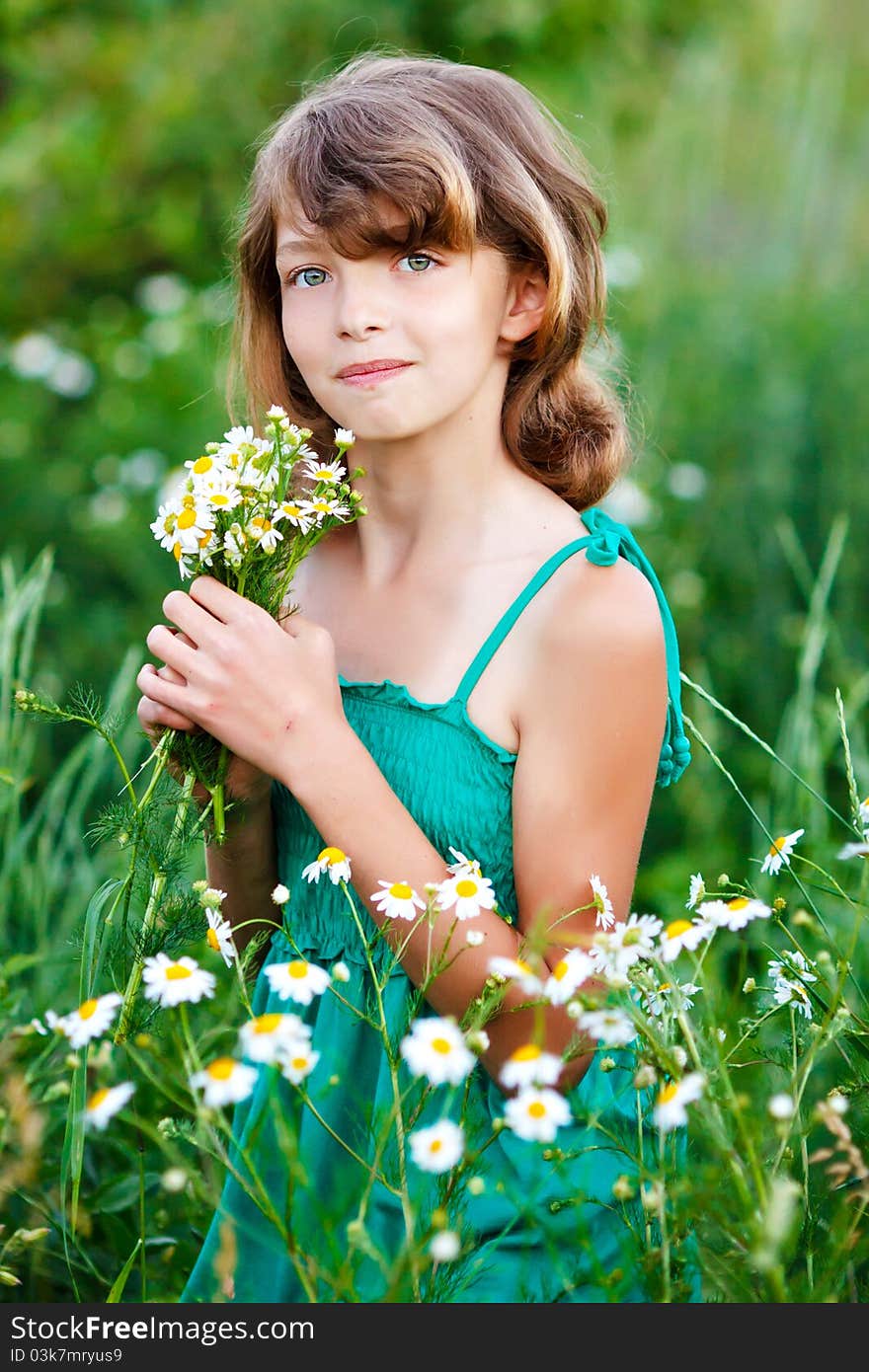 Little girl in the field with flowers. Little girl in the field with flowers