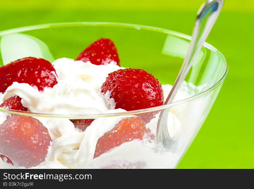 Glass cup with fresh strawberry and cream