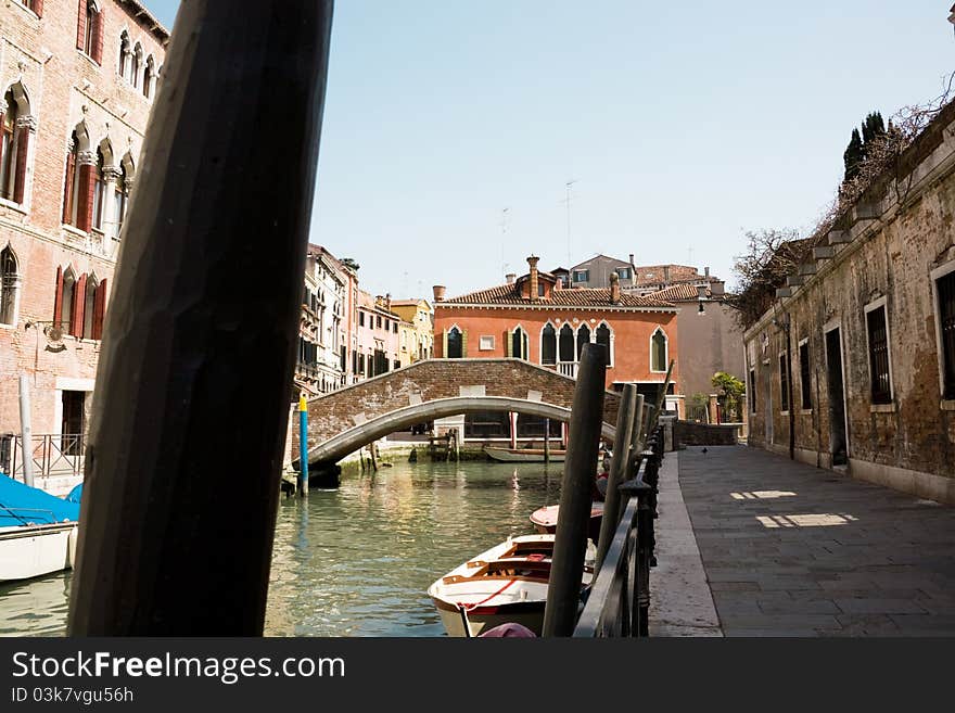 View of venetian canal with red house like a background