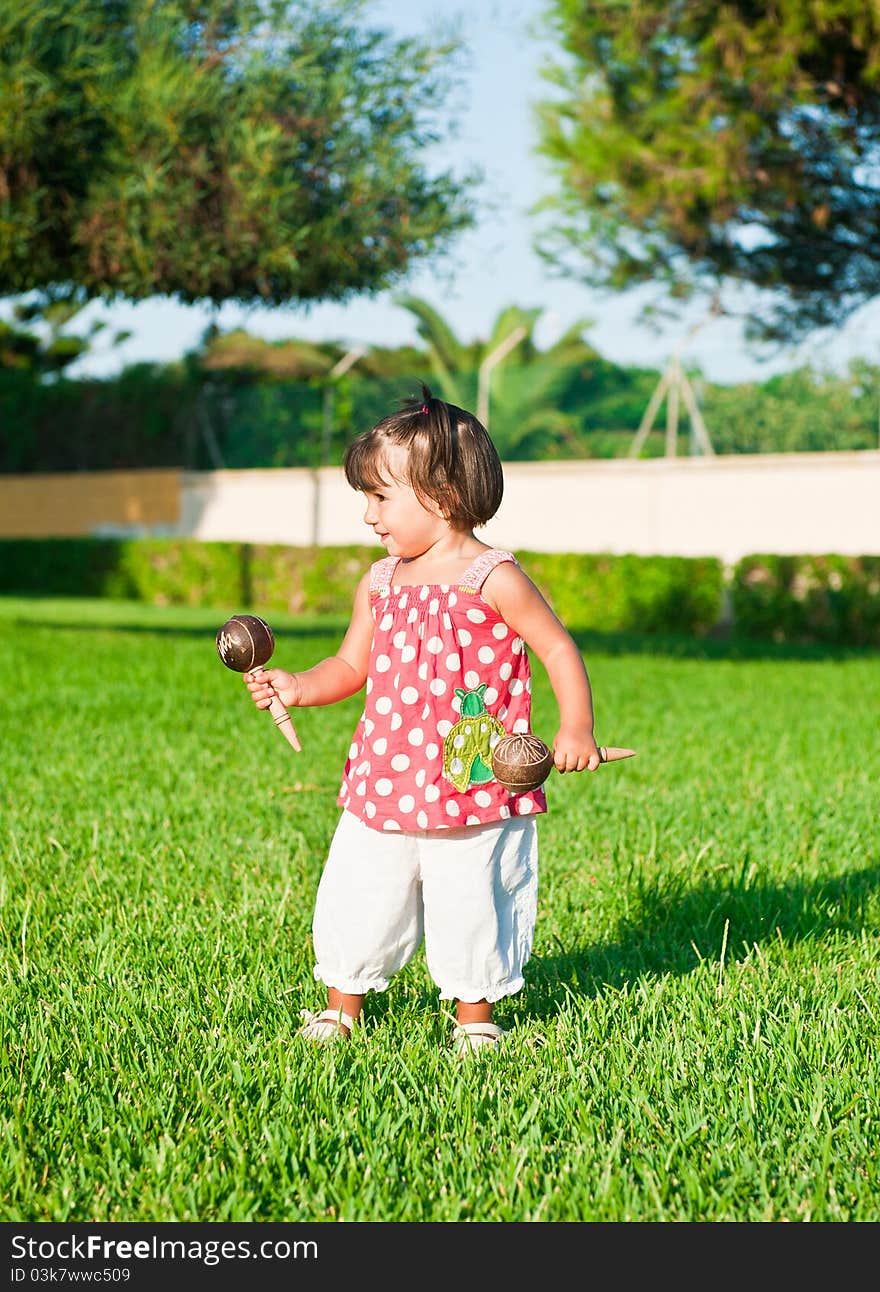 Little girl playing in the streets with tambourines. Little girl playing in the streets with tambourines