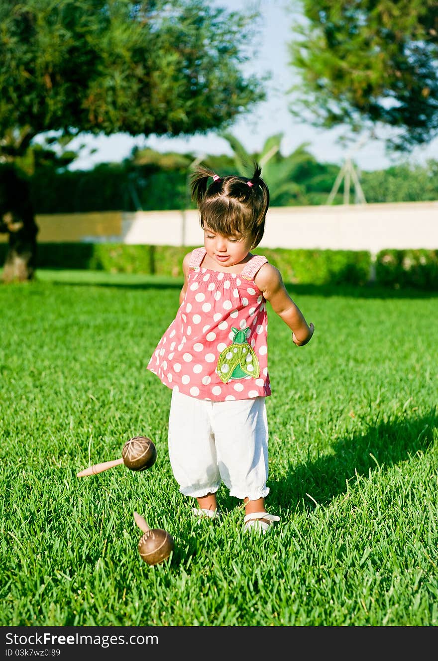 Little girl playing in the streets with tambourines