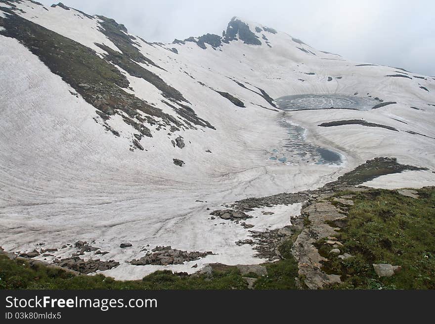 Mountain lake covered with ice