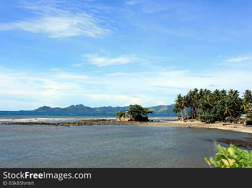 A beach front of a tropical beach resort. A beach front of a tropical beach resort