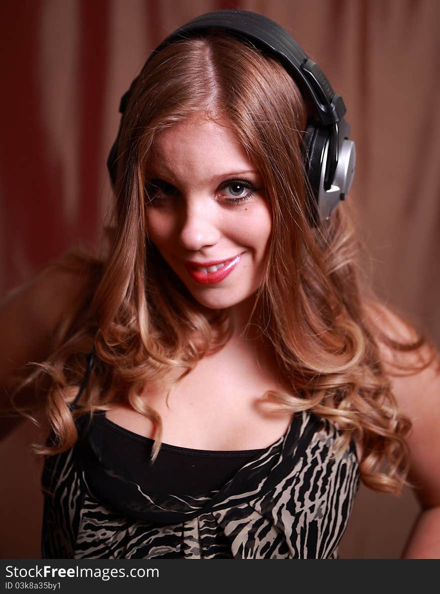 A pretty young woman wearing headphones. A pretty young woman wearing headphones